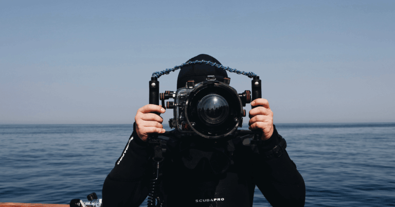 Underwater Photographer who is holding a underwater camera